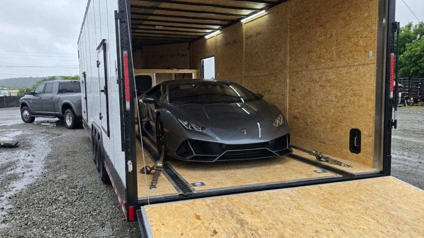Car being loaded into an enclosed trailer